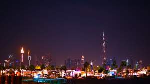 Stunning view of Dubai's illuminated skyline at night featuring the Burj Khalifa.
