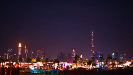 Stunning view of Dubai's illuminated skyline at night featuring the Burj Khalifa.