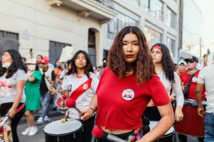 Vibrant street parade with musicians and dancers in Lima, showcasing cultural celebration.