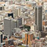 Aerial cityscape of downtown Bogotá featuring modern skyscrapers and urban architecture.
