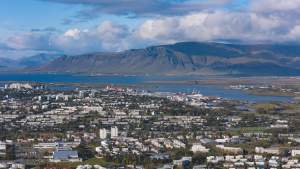 Stunning aerial view of Reykjavik with Esja Mountain in the backdrop during summer.
