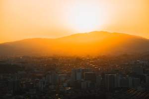 Captivating sunset view over Икеда cityscape with distant mountains in Osaka, Japan.
