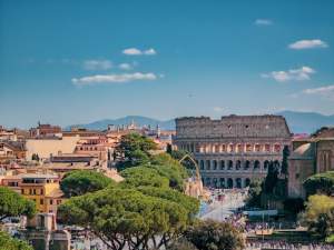 A breathtaking view of Rome featuring the iconic Colosseum on a sunny day.