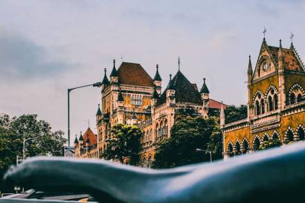 Historic David Sassoon Library in Mumbai showcasing Gothic architectural style in a vibrant city setting.