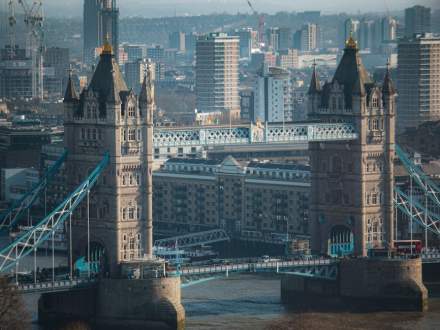 Aerial view of Tower Bridge with London's skyline in the background, capturing urban architecture.